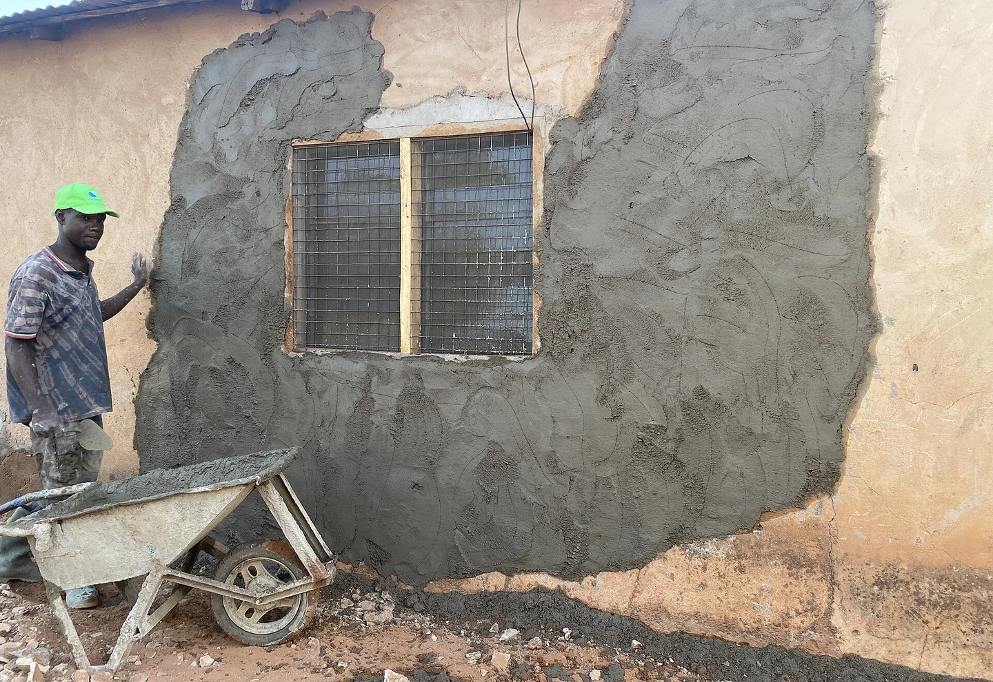 Cement plaster being applied to masonry